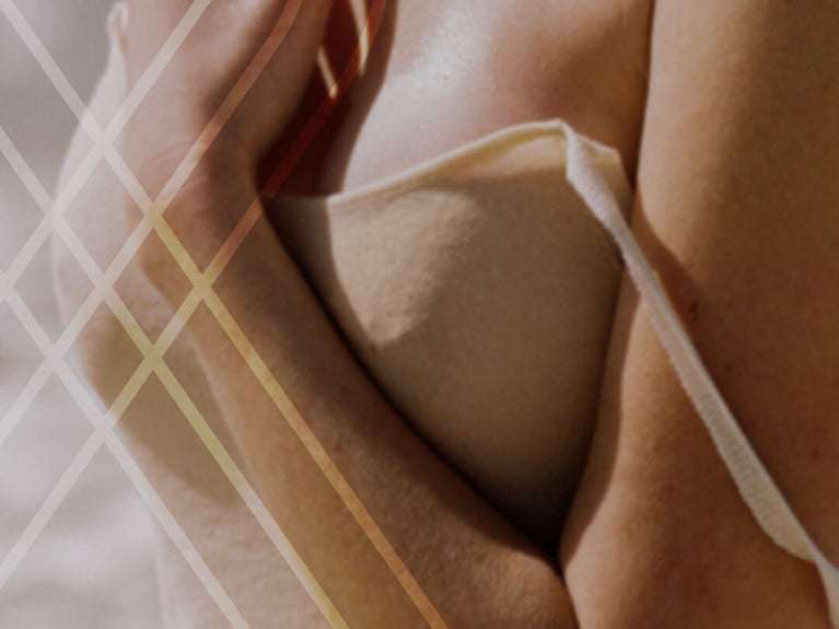 Image of women in tank holding chest